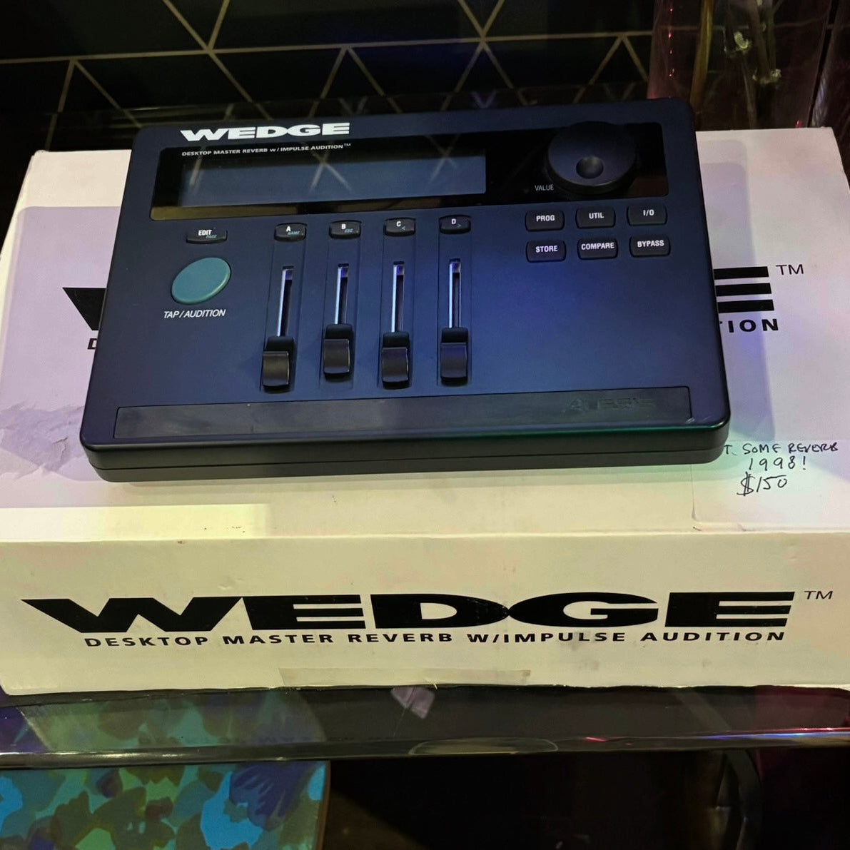 WEDGE desktop master reverb device on a branded box with a tiled wall background