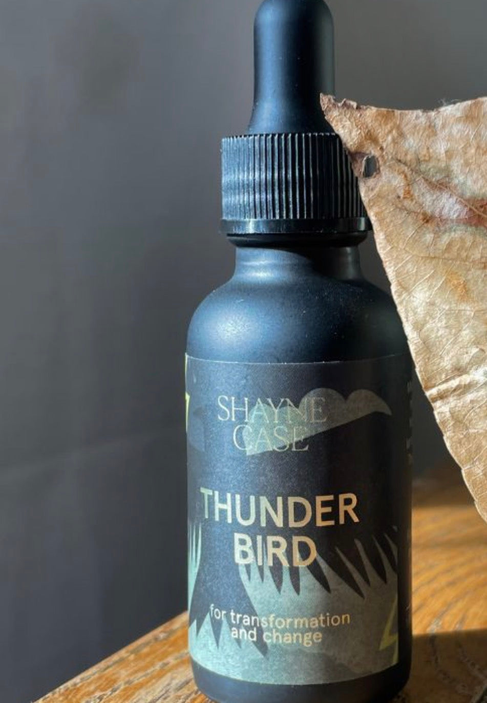 Bottle of 'Thunder Bird' by Shayne Case on a wooden surface with a dark background